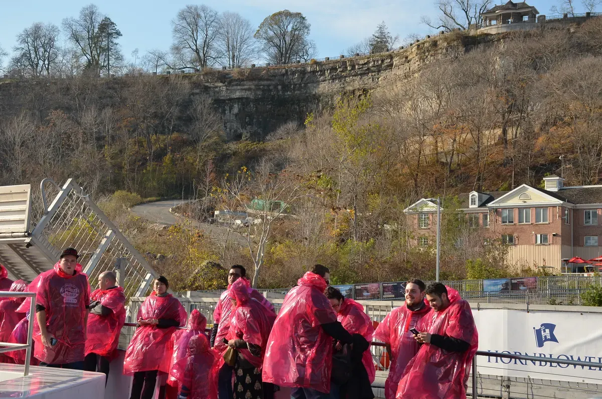Passengers in red ponchos aboard a boat tour on the Niagara River on a Niagara Falls tour from NYC, New York